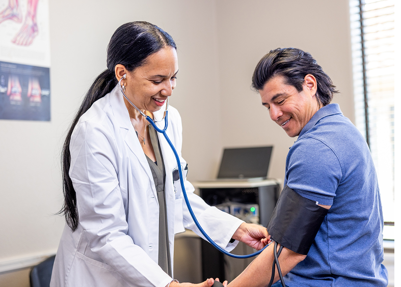 Healthcare professional with stethoscope and patient